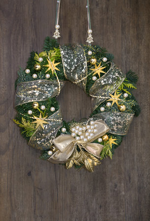 Christmas wreath withden decorations on wooden doorの写真素材