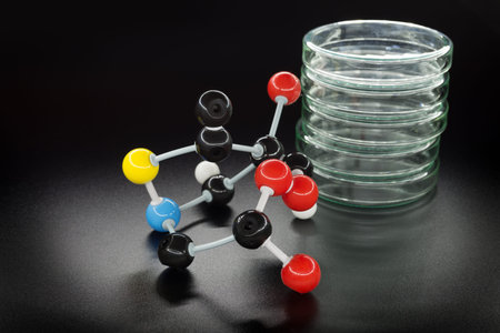 Chemical formula and glass dishes on black background
