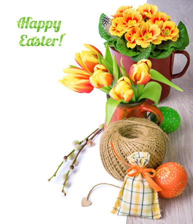 Easter arragement with spring flowers and eggs on wood, left side isolated on white. Space for your textの写真素材