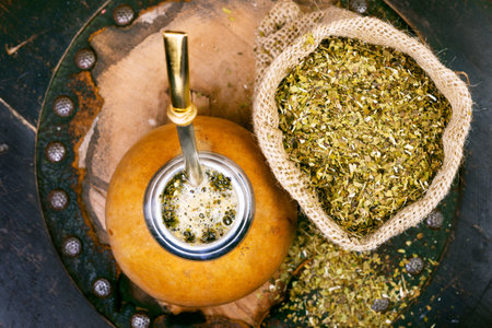 Yerba mate in a traditional calabash gourd and bag of dry herb