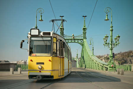 Historic tram on Freedom Bridge in Budapest Hungary on a bright day toned imageのeditorial素材