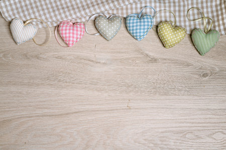 Background for greeting card with stuffed cotton hearts on wood. Design for a new baby greeting or...