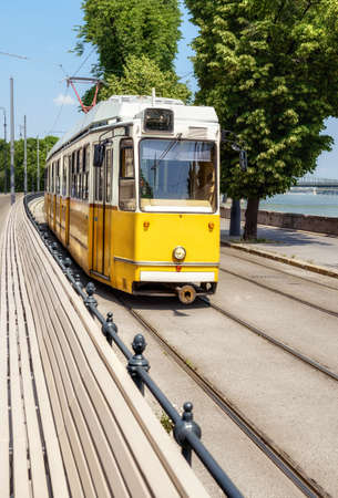 Historic yellow tram in central Budapest by the river early Summerのeditorial素材