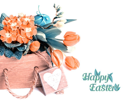 Easter border with orange tulips, primrose and spring decorations, caption Happy Easter!. This image...