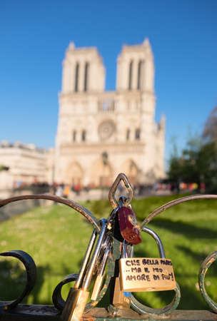 PARIS, FRANCE - APRIL 18, 2016: Love Padlocks in front of Notre Dame Cathedral in Paris. The thousands of locks locked by couples symbolize love forever.のeditorial素材