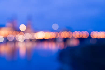Blurred background of Dresden skyline across Elbe river at night. Romantic bokeh lights and blue twilight.の写真素材