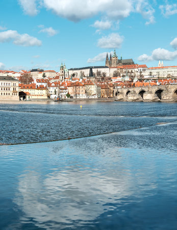 Charles Bridge, St. Vitus Cathedral and other historical buildings in Prague, panorama from the opposite river bank. This image is toned.の写真素材