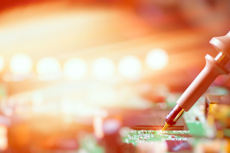Closeup on electronic board in hardware repair shop, toned image. This image is blurred, there is no...