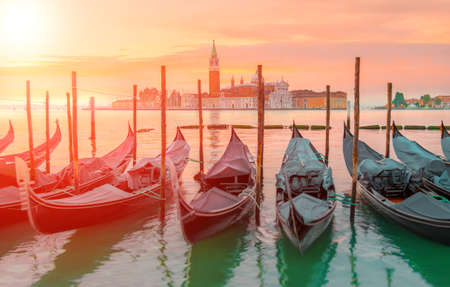 Gondolas moored by Saint Mark square with San Giorgio di Maggiore church in the background - Venice, Venezia, Italy, Europe. This image is toned.の写真素材