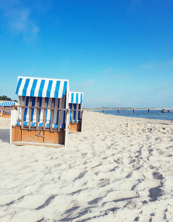 Sandy beach and traditional wooden beach chairs on island Rugen, Northern Germany, on the coast of Baltic Sea. Panorama, this image is toned.のeditorial素材