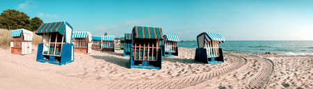 Sandy beach and traditional wooden beach chairs on island Rugen, Northern Germany, on the coast of Baltic Sea. Panorama, this image is toned.のeditorial素材