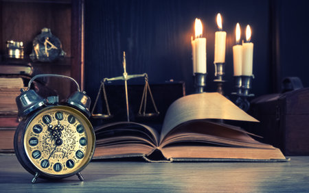 Vintage alarm clock showing five to twelve on the wooden table in study room. Happy New Year 2017!...