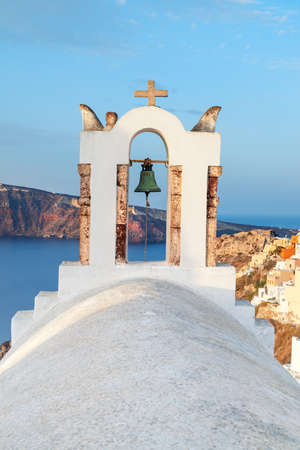 View on Oia village on Santorini island over the bell towers of the local church early in the morningの写真素材