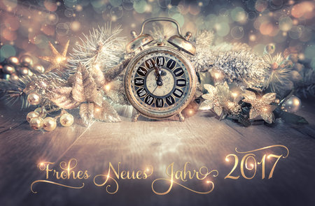 Greeting card with greeting  Frohes Neues Jahr 2017 in German. Vintage alarm clock showing five to...