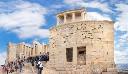 ATHENS, GREECE - OCTOBER 20, 2016: Tourists enter Acropolis fortress through an ancient gateway...