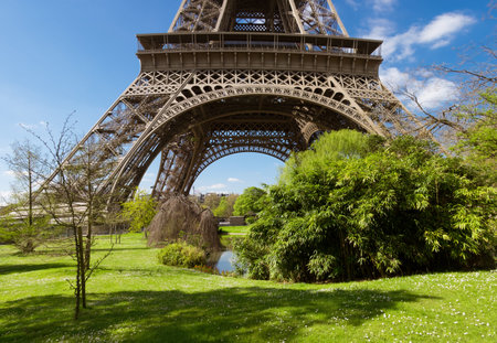 Paris, Eiffel tower on a bright day in Spring, panoramic view with romantic park below the tower