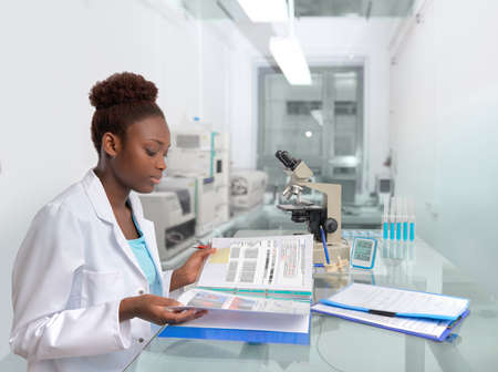 African scientist, medical worker, tech or graduate student works in modern biological laboratoryの写真素材
