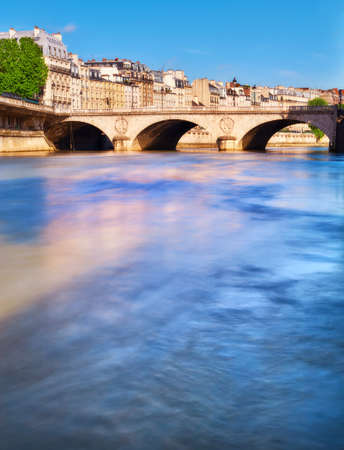The Pont au Change connecting island Ile de la Cite with the Right Bank. Long exposure to poliish water in Seine river.のeditorial素材