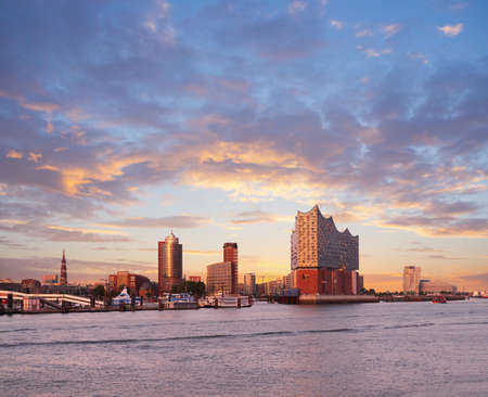 HANBURG, GERMANY- AUGUST 12, 2015: Hambirg, view on the Elbe river towards Elbphilharmonie, a concert hall in the Hafen City at sunset.のeditorial素材