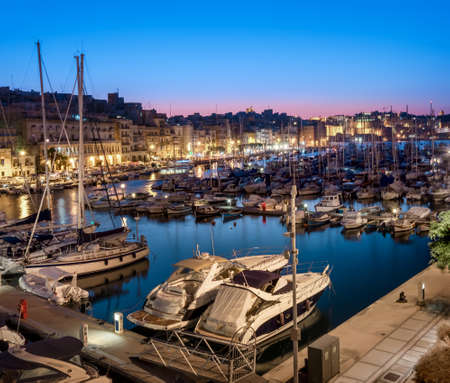 Panorama wth sailing boats on Senglea marina in Grand Bay, Valetta, Malta, on a quiet evening. This image is toned.の写真素材