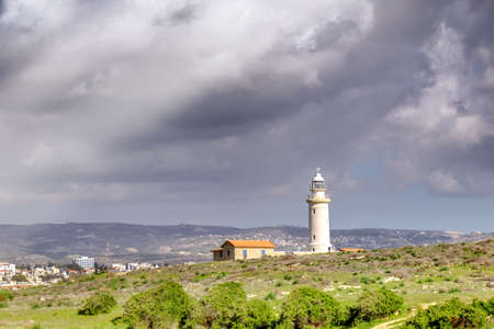 Lighthouse in Pathos, Cyprus island, Greece under dramatic skyの写真素材