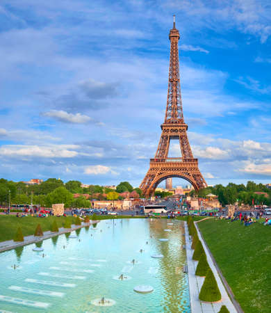 PARIS, FRANCE - MAY 14, 2017: Eiffel tower on a bright afternoon in Spring with many people enjoying the Sun and the view, panoramic image.のeditorial素材