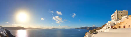 Sunset over Santorini island in Greece. Traditional apartments and houses in Oia village on a sunset, panoramic image.のeditorial素材