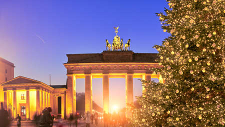 Panoramic image of Brandenburger Gate in Berlin with Christmas tree on a sunset with evening illumination.のeditorial素材