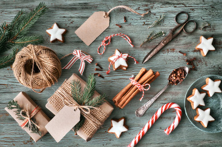 Hand crafted gifts on dark rustic wooden table with Christmas decorations. Seasonal background shot...
