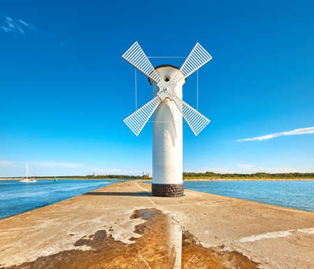 Old lighthouse in Swinoujscie, a port in Poland on the Baltic Sea. The lighthouse was designed as a traditional windmill. Panoramic image.の写真素材