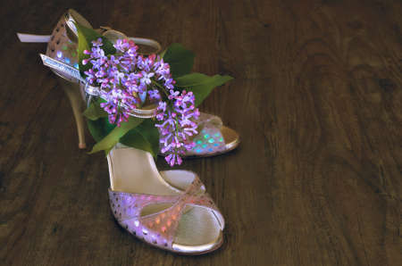 Argentine tango stilettos and lilac flower on dark wooden floor, text spaceの写真素材