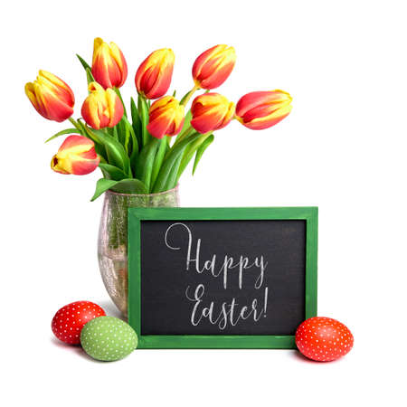 Bunch of red tulips with yellow tops, chalk board and colored Easter eggs on white background. Text "Frohe Ostern" means "Happy Easter" in German. の写真素材
