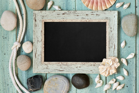 Blackboard With Maritime Decorations on light turquoise wood, text space