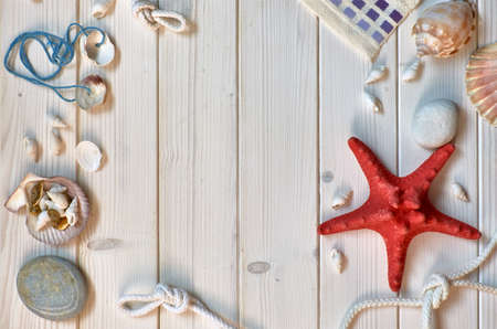 Maritime Decorations - stones, shells and knots - on light wooden planks. Overhead shot, text spaceの写真素材