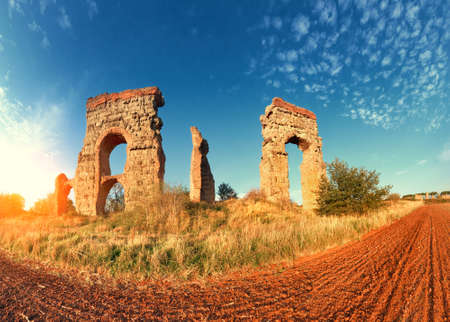 Ruins of the ancient aqueduct near Villa Quintili on Appia Way in Rome, Italyの写真素材