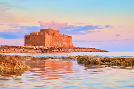Pafos Harbour Castle (Turkish Castle) in Pathos, Cyprus, on a sunset