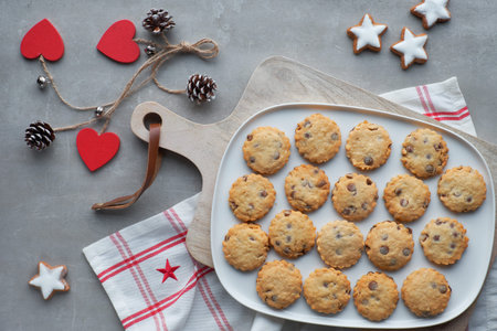 Christmas chocolate chip cookies, flat lay with spices and winter decorations