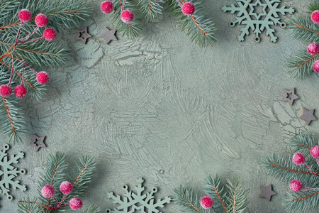 Christmas frame with fir twigs, frosted berries, stars and snowflakes. Green textured background,...