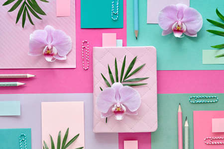 Floral paper  in pink and mint colors. Orchid flowers on geometric  with copy-space.の写真素材