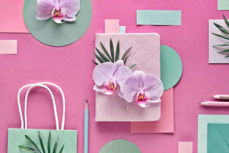 Floral paper  in pink and mint colors. Orchid flowers on geometric  with copy-space.の写真素材