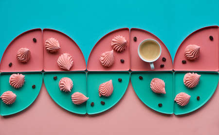 Geometric paper  in mint and coral colors with coffee and marshmallowsの写真素材