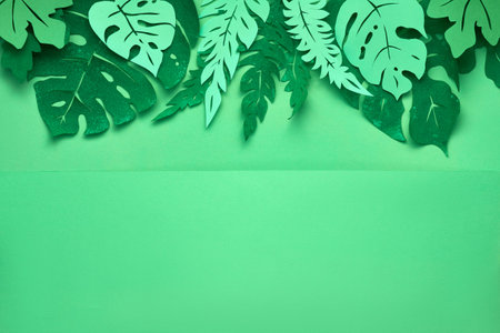 Floral flat lay with tropical leaves made out of paper, space for your text