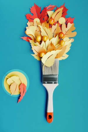 dav_softTop view on flat lay with brush loaded with paint made from paper Autumn leaves. Concept home renovation background in blue, yellow, orange and red colors.の写真素材