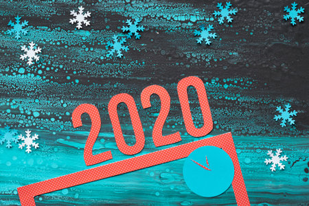 Christmas background in blue, red and black, top view on red frame and number 2020 on abstract...