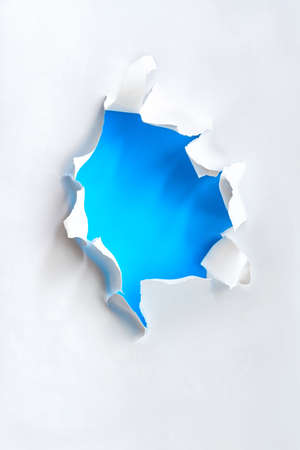 Teared paper hole, flat lay in white and mint color, text spaceの写真素材