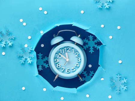 Happy New Year 2020! Aarm clock in paper hole, flat lay on blue color paperの写真素材