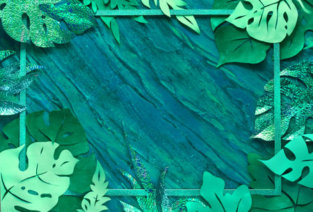 Paper craft background, frame made of exotic tropical leaves with text space on dark textured...