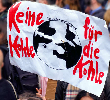 Placard "No coal for the carbon" in German language on a global climate strike by Brandenburg gate in Berlinの写真素材