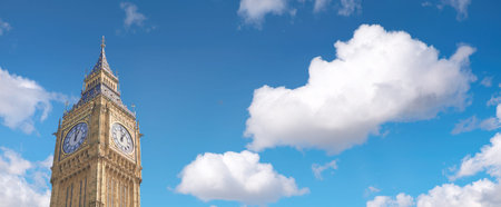 Big Ben Clock Tower in London, UK, on a bright day. Panoramic image, text space on blue sky...