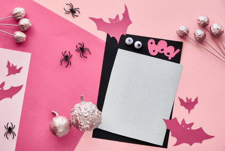 Creative paper craft Halloween flat lay in pink and black colors. Top view with cipy-space on stack...